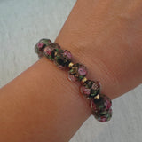 Stretch bracelet with faceted beads in white, black, and amber tones – versatile and elegant for layering