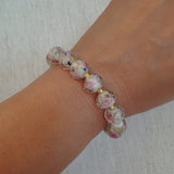 Stretch bracelet with faceted beads in white, black, and amber tones – versatile and elegant for layering