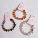 Stretch bracelet with faceted beads in white, black, and amber tones – versatile and elegant for layering
