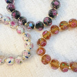 Stretch bracelet with faceted beads in white, black, and amber tones – versatile and elegant for layering