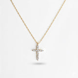Delicate cross pendant necklace featuring shimmering cubic zirconia accents on a fine gold-tone chain, offering a subtle yet radiant touch for everyday elegance.