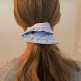 Chic hair scrunchie with a classic preppy design, featuring bold contrasting borders and a tailored look—perfect for polished, everyday styling