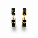 Pair of gold hoop earrings with black stones on a white background