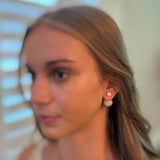 Shiny gold tone disco ball earrings with an elegant pearl back detail, adding a fun yet classy twist to your party look.