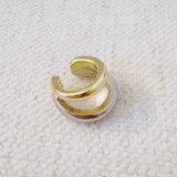 Stylish ear cuff featuring a dual-tone design with gold and silver finishes—offering a bold, modern look without the need for a piercing.