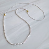 Set of two versatile pearl necklaces featuring luminous pearls in varying sizes, designed with magnetic clasps for easy wear and styling; can be worn individually or linked together for a longer layered look.