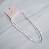 Set of two versatile pearl necklaces featuring luminous pearls in varying sizes, designed with magnetic clasps for easy wear and styling; can be worn individually or linked together for a longer layered look.