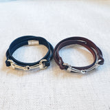 Equestrian-inspired double wrap bracelets featuring black and brown leather bands with horse bit accents in gold and silver tones.