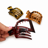 Three tortoiseshell hair clips on a white background