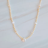 Gold-tone chain necklace featuring a mix of small polished pearls and irregular freshwater-style pearls, finished with an adjustable clasp closure.