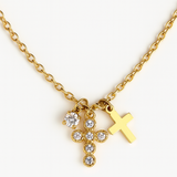 Gold-toned dual cross necklace featuring two layered cross pendants on a delicate chain for a bold, faith-inspired look