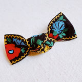 Elegant hair clip featuring intricate French floral embroidery on a soft fabric base—offering a timeless, romantic accent to any hairstyle.