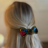 Elegant hair clip featuring intricate French floral embroidery on a soft fabric base—offering a timeless, romantic accent to any hairstyle.