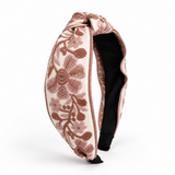 Decorative headband with floral pattern on a white background