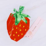 Cute and colorful strawberry-shaped hair claw clip with a glossy finish, perfect for adding a fresh and playful touch to any hairstyle.