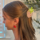 Cute and colorful strawberry-shaped hair claw clip with a glossy finish, perfect for adding a fresh and playful touch to any hairstyle.