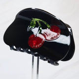 Playful cherry-themed hair claw clip featuring bright red cherries and green stems, adding a sweet and fruity flair to any hairstyle.