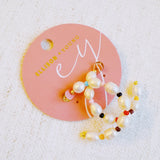 Stylish hoop earrings featuring freshwater pearls paired with colorful accent beads, creating a vibrant and chic look.