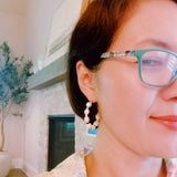 Stylish hoop earrings featuring freshwater pearls paired with colorful accent beads, creating a vibrant and chic look.