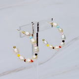 Stylish hoop earrings featuring freshwater pearls paired with colorful accent beads, creating a vibrant and chic look.