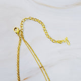 Collar a capas con cruz y monedas