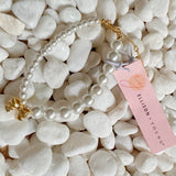 Pulsera de perlas con lazo colgante