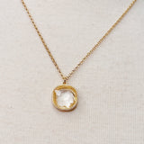 Gold chain necklace featuring a cushion-cut clear crystal pendant with a textured gold bezel, radiating timeless shine and elegance.