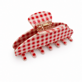 Red and white checkered hair clip on a white background