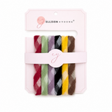 Set of colorful hair ties in a branded package on a white background