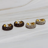 A pair of gold-tone hoop earrings adorned with shimmering rhinestones