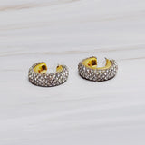 A pair of gold-tone hoop earrings adorned with shimmering rhinestones