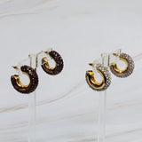 A pair of gold-tone hoop earrings adorned with shimmering rhinestones