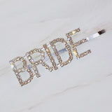 Elegant set of two gold and silver hair pins featuring sparkling "Bride" lettering and glam crystal accents—perfect for bridal showers, bachelorette parties, or wedding day styling.