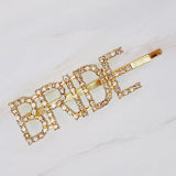 Elegant set of two gold and silver hair pins featuring sparkling "Bride" lettering and glam crystal accents—perfect for bridal showers, bachelorette parties, or wedding day styling.