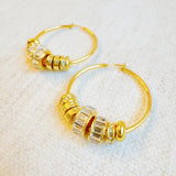 Elegant hoop earrings adorned with shimmering crystal accents and nature-inspired details—perfect for adding a touch of glam and garden charm to any outfit.