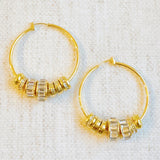 Elegant hoop earrings adorned with shimmering crystal accents and nature-inspired details—perfect for adding a touch of glam and garden charm to any outfit.