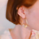Elegant hoop earrings adorned with shimmering crystal accents and nature-inspired details—perfect for adding a touch of glam and garden charm to any outfit.