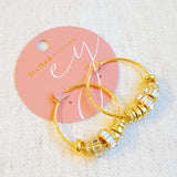 Elegant hoop earrings adorned with shimmering crystal accents and nature-inspired details—perfect for adding a touch of glam and garden charm to any outfit.
