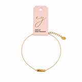 pink card with gold chain with side hanging fish charm on white background