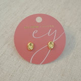 Gold-tone dome stud earrings with a smooth, pebble-like shape and a polished finish for a modern, minimalist look.