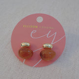 Gold-tone stud earrings featuring a rich espresso-colored drop accent with a sleek and modern silhouette.