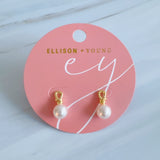 Elegant pearl drop earrings featuring smooth white pearls suspended from sculpted gold loops. The design blends modern artistry with timeless sophistication, creating a refined accessory for everyday or formal wear.