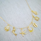 Brass gold necklace with multiple shell and sea charms
