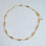 Gold-toned necklace featuring sleek tube beads – minimalist and modern layered style