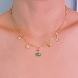Gold chain necklace featuring charming golf-themed pendants, including a golf club, golf ball, flag, and green, making it a perfect accessory for golf enthusiasts.