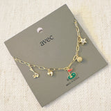 Gold chain necklace featuring charming golf-themed pendants, including a golf club, golf ball, flag, and green, making it a perfect accessory for golf enthusiasts.