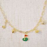 Gold chain necklace featuring charming golf-themed pendants, including a golf club, golf ball, flag, and green, making it a perfect accessory for golf enthusiasts.
