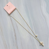 An elegant gold-tone necklace featuring a cross pendant made of luminous pearls with a sparkling crystal at the center. The pendant hangs from a 24-inch chain with a 2-inch extender, creating a timeless and graceful look perfect for layering or wearing solo.