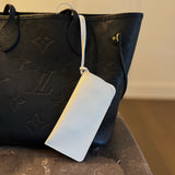 Glass case bag charm with an open-top design and strap attachment, perfect for hanging on your bag to hold glasses or other small essentials in style.