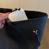 Glass case bag charm with an open-top design and strap attachment, perfect for hanging on your bag to hold glasses or other small essentials in style.